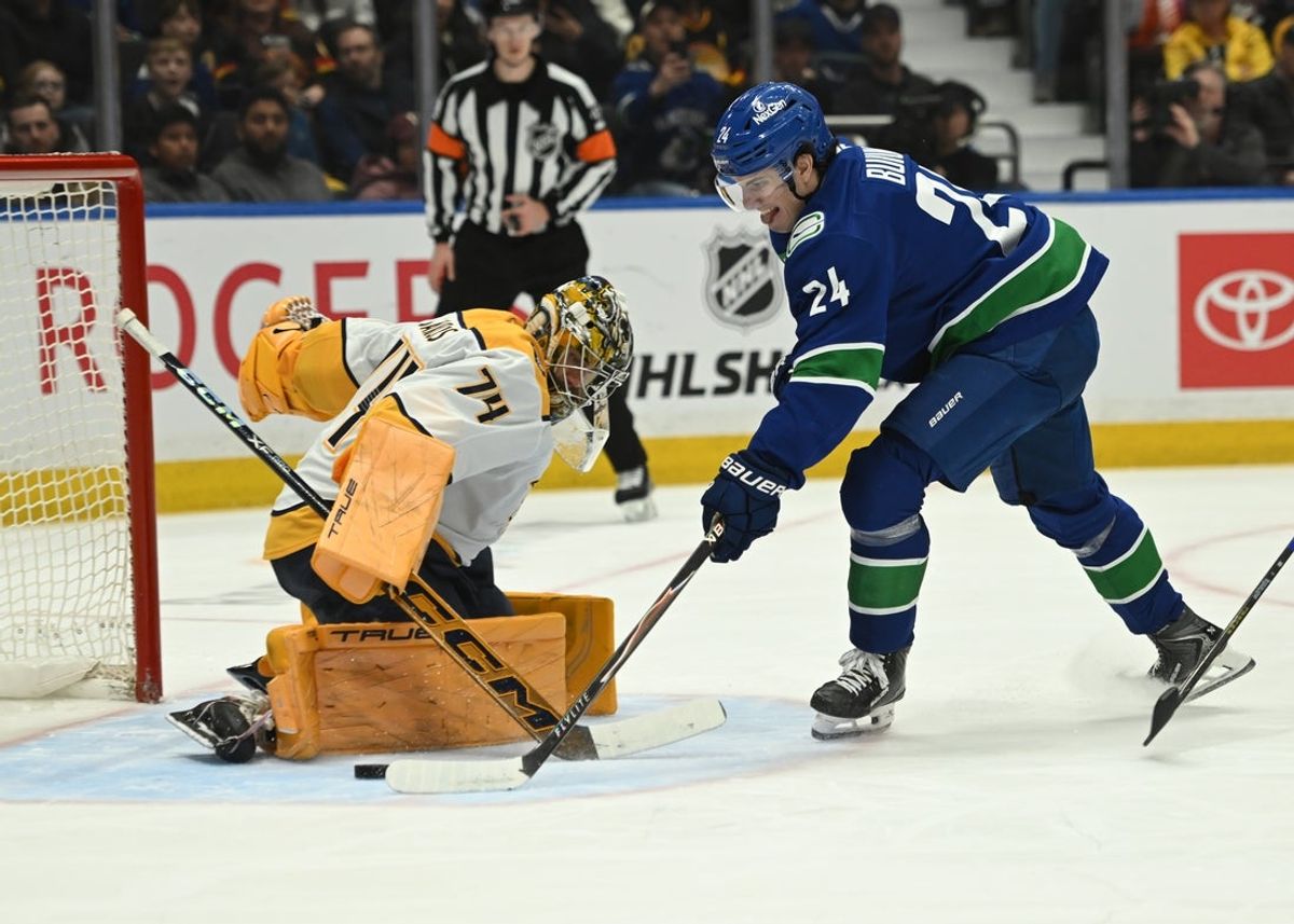 Mar 12, 2026; Vancouver, British Columbia, CAN;Vancouver Canucks defenseman Zeev Buium (24) shoots the puck on Nashville Predators goaltender Juuse Saros (74) during the second period at Rogers Arena. Mandatory Credit: Simon Fearn-Imagn Images