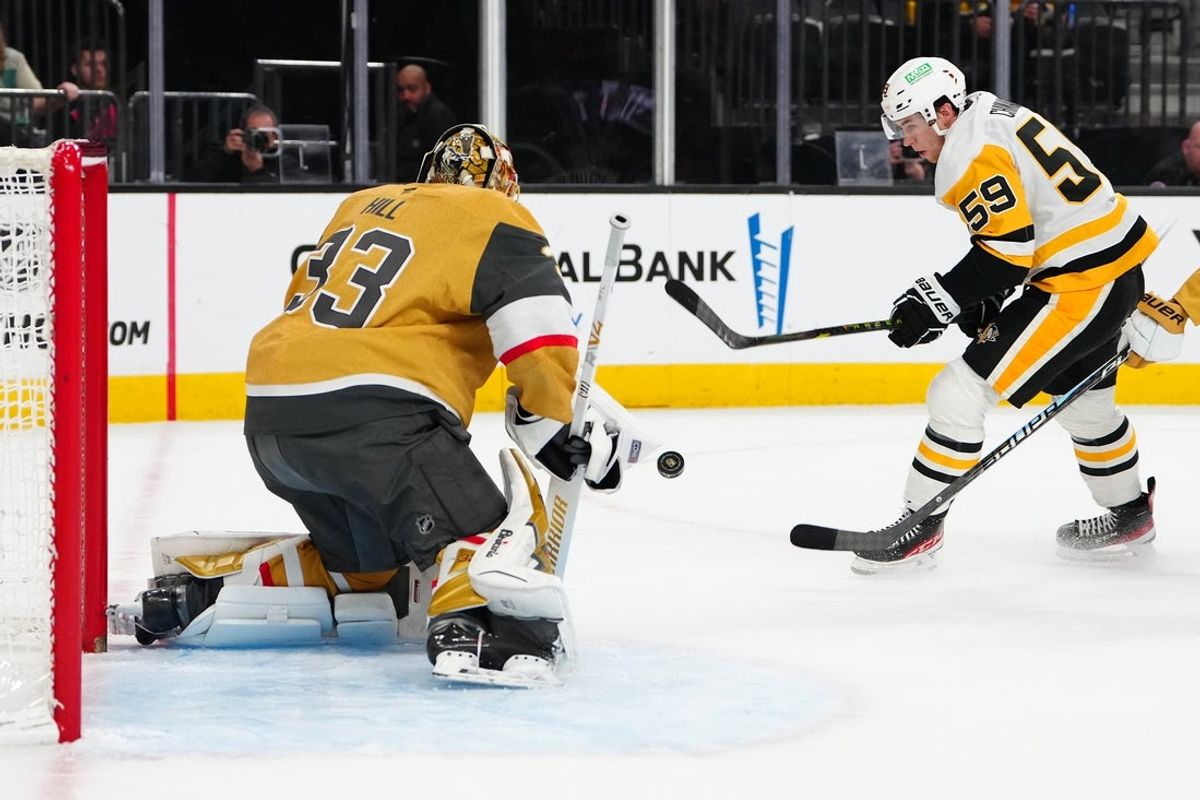 Mar 12, 2026; Las Vegas, Nevada, USA;Pittsburgh Penguins right wing Egor Chinakhov (59) shoots towards Vegas Golden Knights goaltender Adin Hill (33) during the second period  at T-Mobile Arena. Mandatory Credit: Stephen R. Sylvanie-Imagn Images