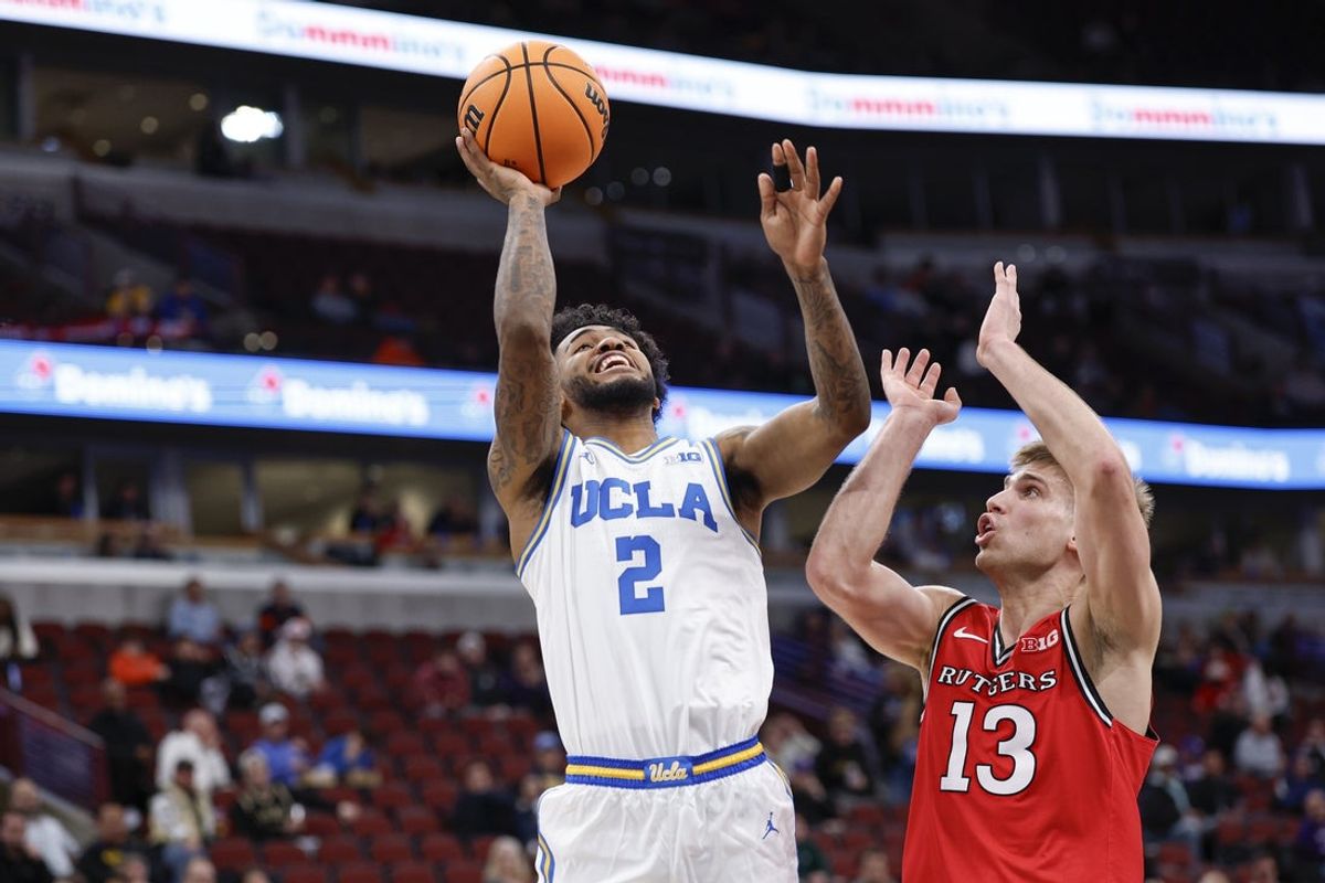 Mar 12, 2026; Chicago, IL, USA; UCLA Bruins guard Donovan Dent (2) drives to the basket against Rutgers Scarlet Knights guard Harun Zrno (13) during the second half at United Center. Mandatory Credit: Kamil Krzaczynski-Imagn Images