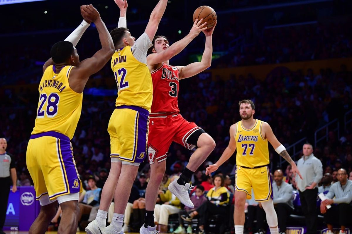 Mar 12, 2026; Los Angeles, California, USA; The Los Angeles Lakers and Chicago Bulls are two of the teams projected to have available cap space as NBA free agency begins. Chicago Bulls guard Josh Giddey (3) moves to the basket against Los Angeles Lakers forward Jake LaRavia (12) and forward Rui Hachimura (28) during the second half at Crypto.com Arena. Mandatory Credit: Gary A. Vasquez-Imagn Images