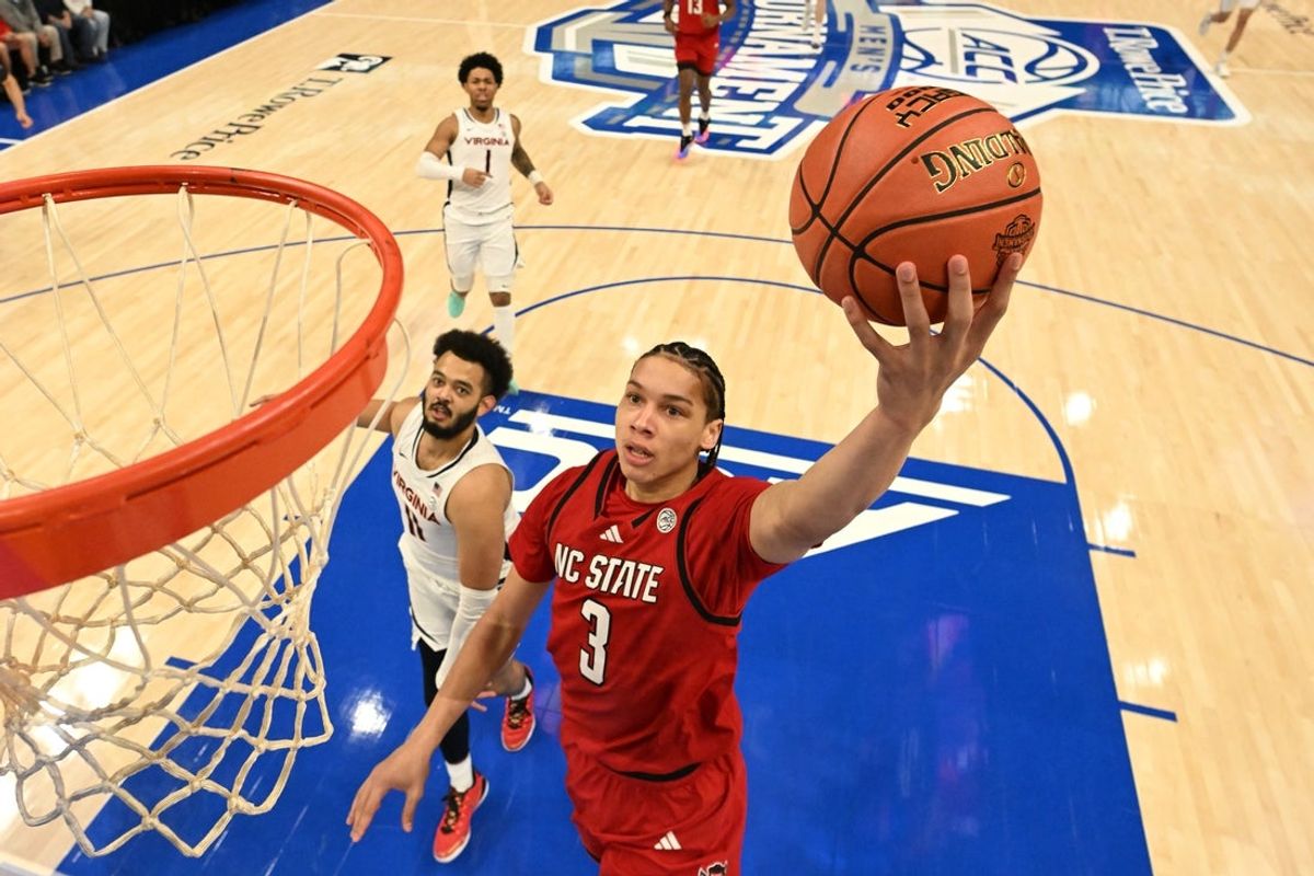 Mar 12, 2026; Charlotte, NC, USA; NC State Wolfpack guard Matt Able (3) scores as Virginia Cavaliers forward Devin Tillis (11) defends in the first half at Spectrum Center. Mandatory Credit: Bob Donnan-Imagn Images