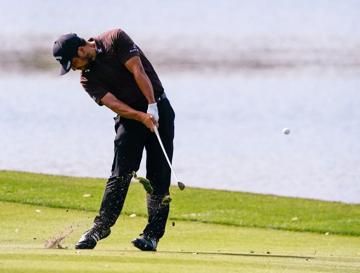 Mar 13, 2026; Ponte Vedra Beach, Florida, USA; Xander Schauffele plays his approach shot to the 18th hole during the second round of THE PLAYERS Championship golf tournament. Mandatory Credit: Jeff Romance-Imagn Images