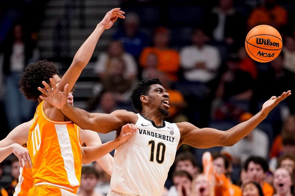 Vanderbilt forward Ak Okereke (10) and Tennessee forward Nate Ament (10) fight for the ball during the first half of a SEC tournament quarterfinal game at Bridgestone Arena in Nashville, Tenn., Friday, March 13, 2026.