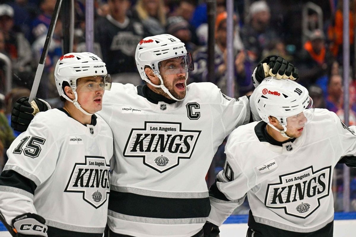 Mar 13, 2026; Elmont, New York, USA;  Los Angeles Kings center Anze Kopitar (11) celebrates his goal with Los Angeles Kings left wing Artemi Panarin (10) and Los Angeles Kings center Alex Turcotte (15) against the New York Islanders during the first period at UBS Arena. Mandatory Credit: Dennis Schneidler-Imagn Images