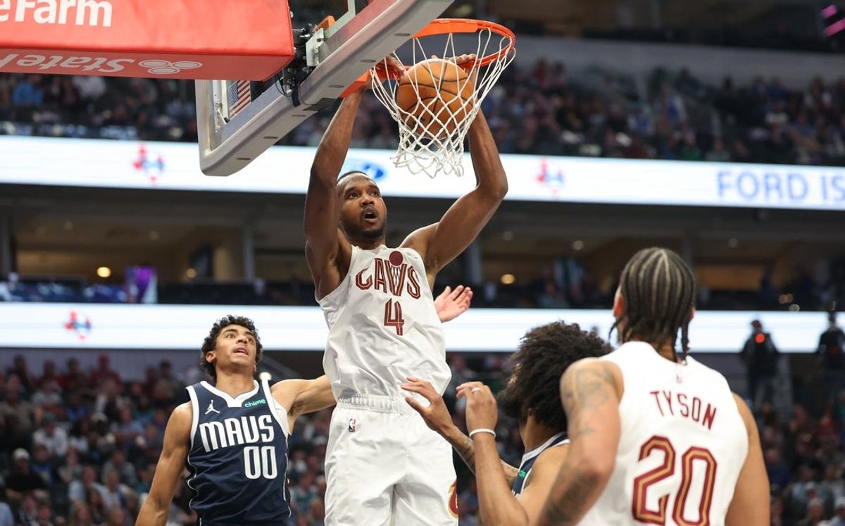 Mar 13, 2026; Dallas, Texas, USA;  Cleveland Cavaliers center Evan Mobley (4) dunks past Dallas Mavericks guard Max Christie (00) during the first half at American Airlines Center. Mandatory Credit: Kevin Jairaj-Imagn Images
