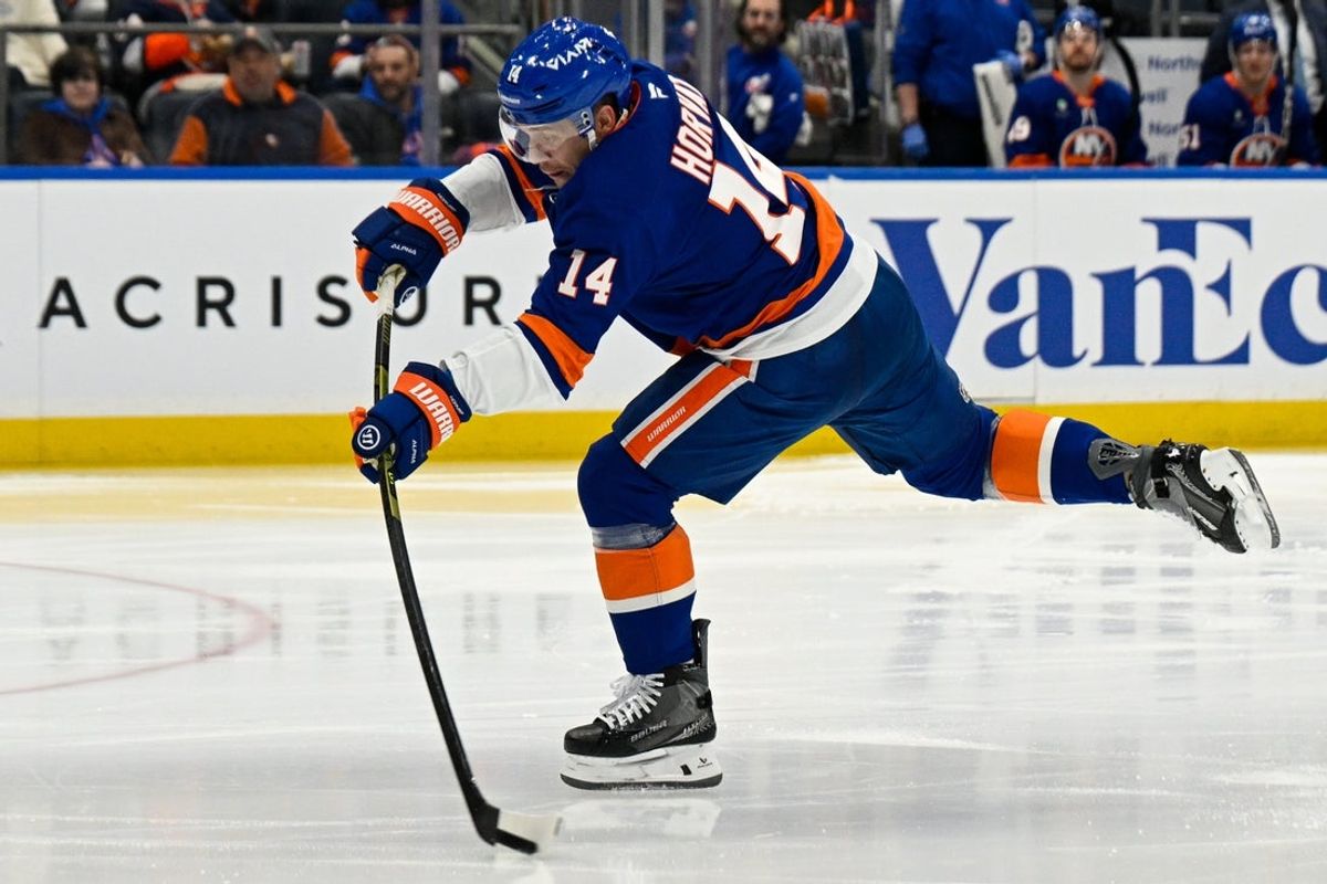 Mar 13, 2026; Elmont, New York, USA; New York Islanders center Bo Horvat (14) attempts a shot against the Los Angeles Kings second during the second period at UBS Arena. Mandatory Credit: Dennis Schneidler-Imagn Images