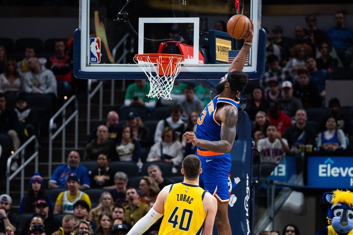 Mar 13, 2026; Indianapolis, Indiana, USA; New York Knicks center/forward Mitchell Robinson (23) shoots the ball while Indiana Pacers center Ivica Zubac (40) defends in the first half at Gainbridge Fieldhouse. Mandatory Credit: Trevor Ruszkowski-Imagn Images