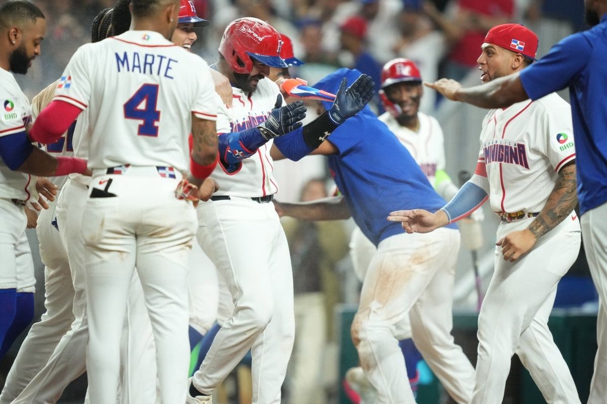 Mar 13, 2026; Miami, FL, United States; Dominican Republic catcher Austin Wells, center, is mobbed by teammates after hitting a walk-off home run in the seventh inning against Korea during a quarterfinal game of the 2026 World Baseball Classic at loanDepot Park. Mandatory Credit: Jim Rassol-Imagn Images