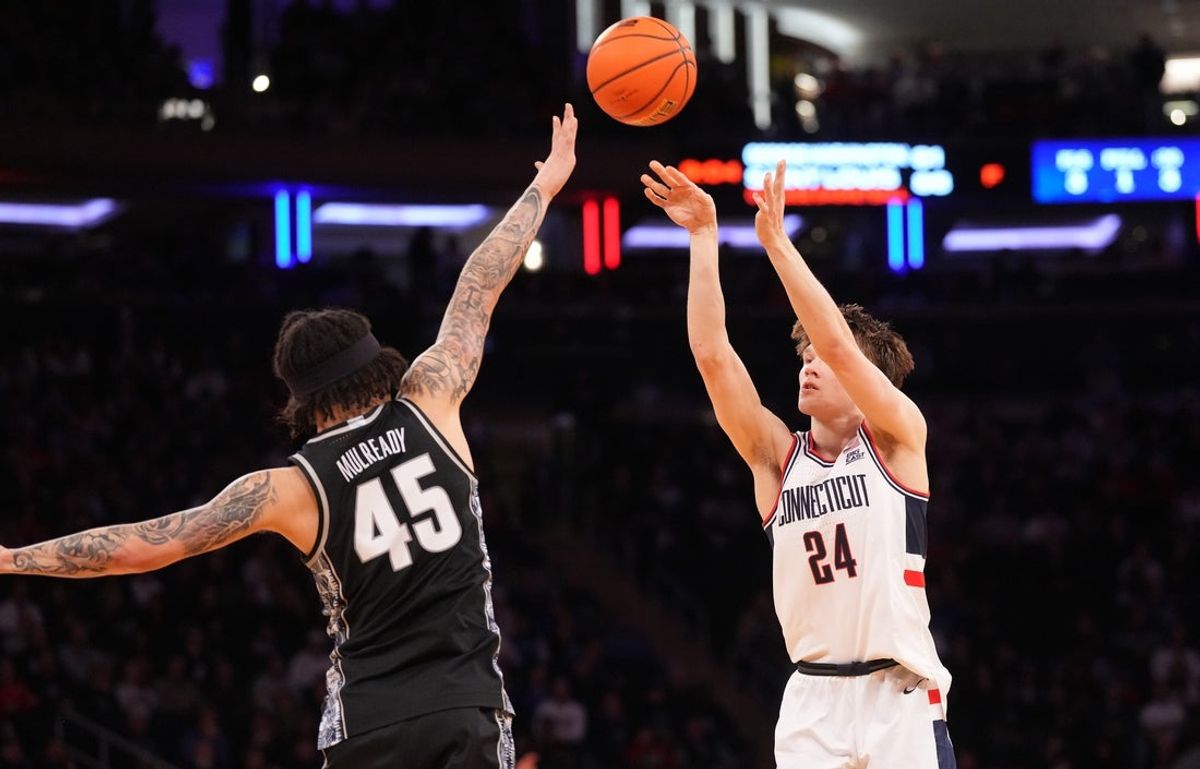 Mar 13, 2026; New York, NY, USA;  UConn Huskies guard Braylon Mullins (24) shoots over Georgetown Hoyas guard Kayvaun Mulready (45) during the first half at Madison Square Garden. Mandatory Credit: Robert Deutsch-Imagn Images