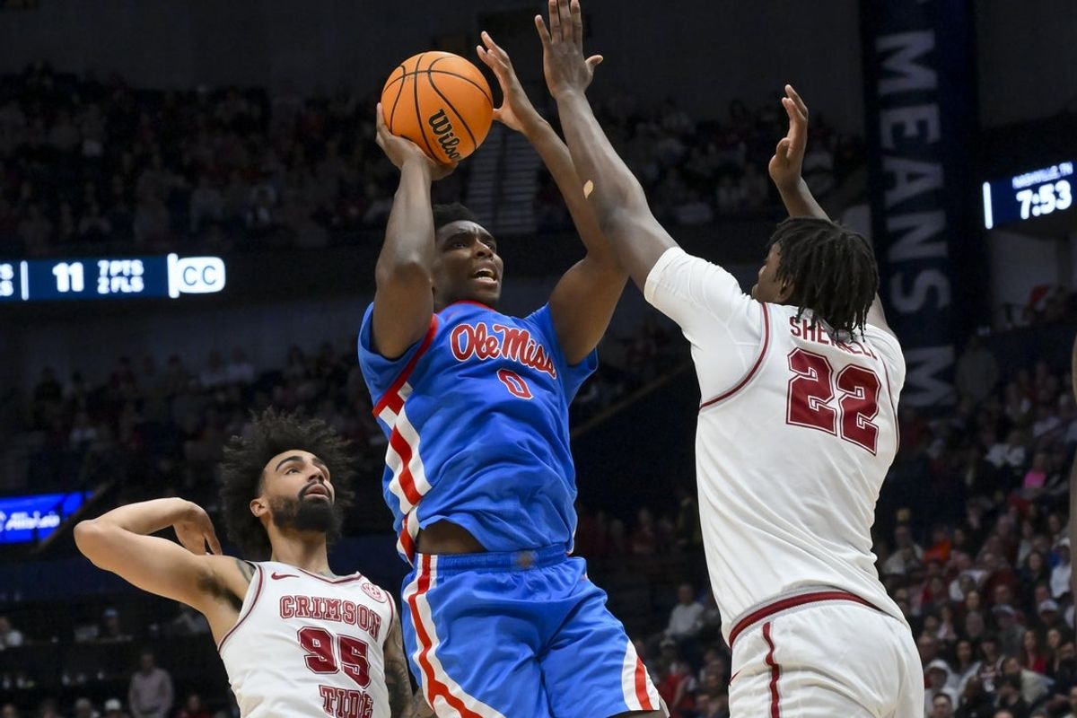 Mar 13, 2026; Nashville, TN, USA;  Mississippi Rebels forward Malik Dia (0) shoots over Alabama Crimson Tide forward Aiden Sherrell (22) during the second half at Bridgestone Arena. Mandatory Credit: Steve Roberts-Imagn Images