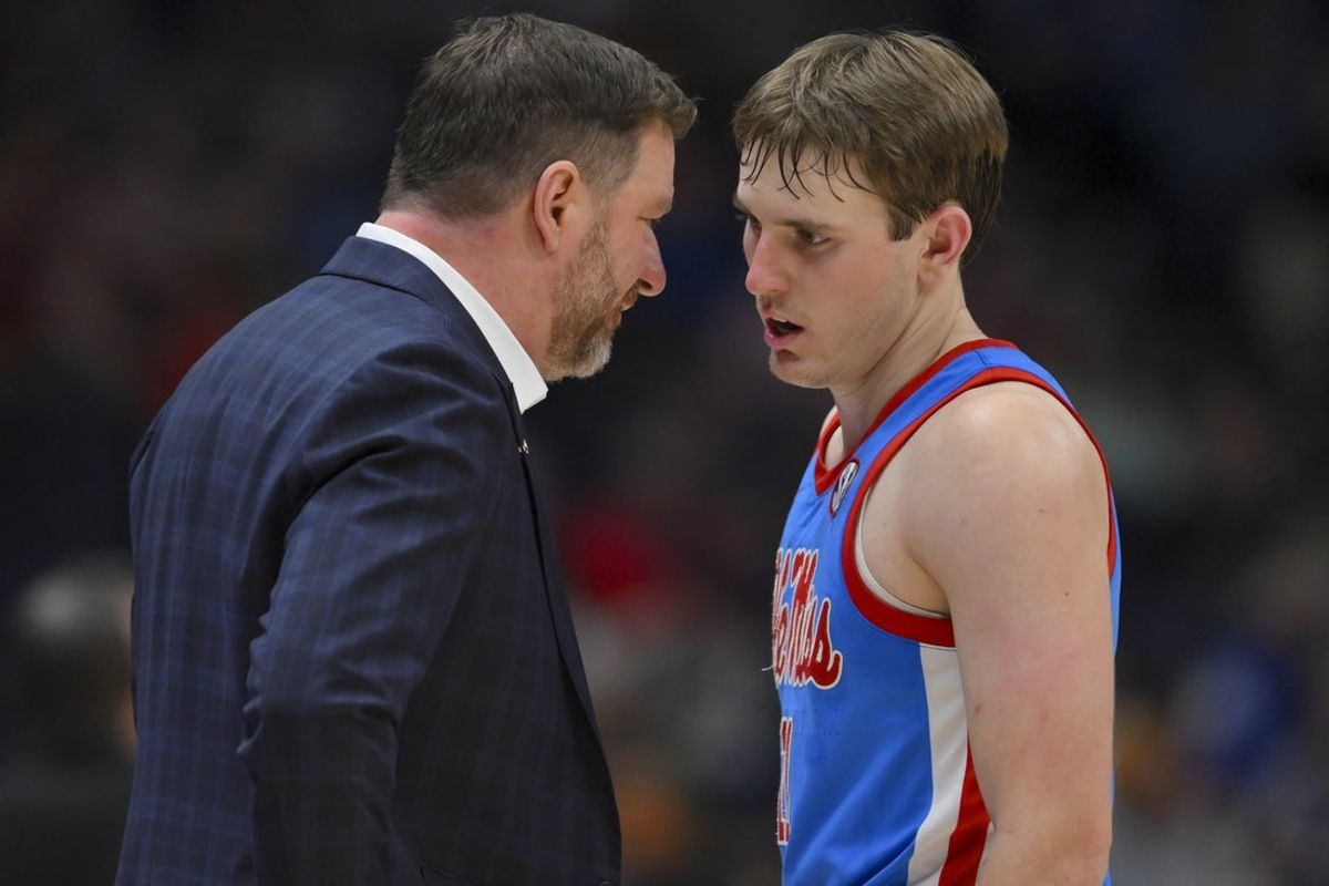 Mar 13, 2026; Nashville, TN, USA;  Mississippi Rebels head coach Chris Beard talks with guard Travis Perry (11) during a break in action against the Alabama Crimson Tide during the second half at Bridgestone Arena. Mandatory Credit: Steve Roberts-Imagn Images