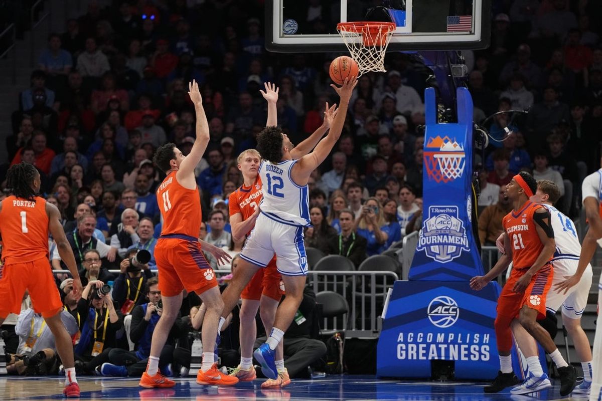 Mar 13, 2026; Charlotte, NC, USA; Duke Blue Devils forward Cameron Boozer (12) shoots as Clemson Tigers forward Nick Davidson (11) and forward Chase Thompson (3) defends in the first half at Spectrum Center. Mandatory Credit: Bob Donnan-Imagn Images