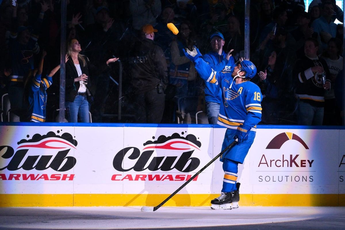 Mar 13, 2026; St. Louis, Missouri, USA; St. Louis Blues center Robert Thomas (18) tosses a t-shirt in to the crowd after he was named first star of the game after scoring a game winning goal in overtime against the Edmonton Oilers at Enterprise Center. Mandatory Credit: Jeff Curry-Imagn Images