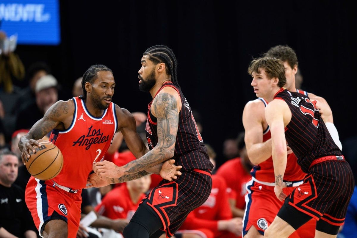 Mar 13, 2026; Inglewood, California, USA; Los Angeles Clippers forward Kawhi Leonard (2) controls the ball while under pressure from Chicago Bulls center Nick Richards (13), center, during the first half at Intuit Dome. Mandatory Credit: William Liang-Imagn Images