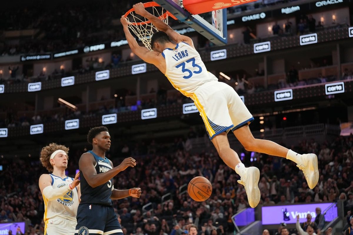 Mar 13, 2026; San Francisco, California, USA; Golden State Warriors forward Malevy Leons (33) hangs on the rim after dunking the ball against the Minnesota Timberwolves in the fourth quarter at the Chase Center. Mandatory Credit: Cary Edmondson-Imagn Images