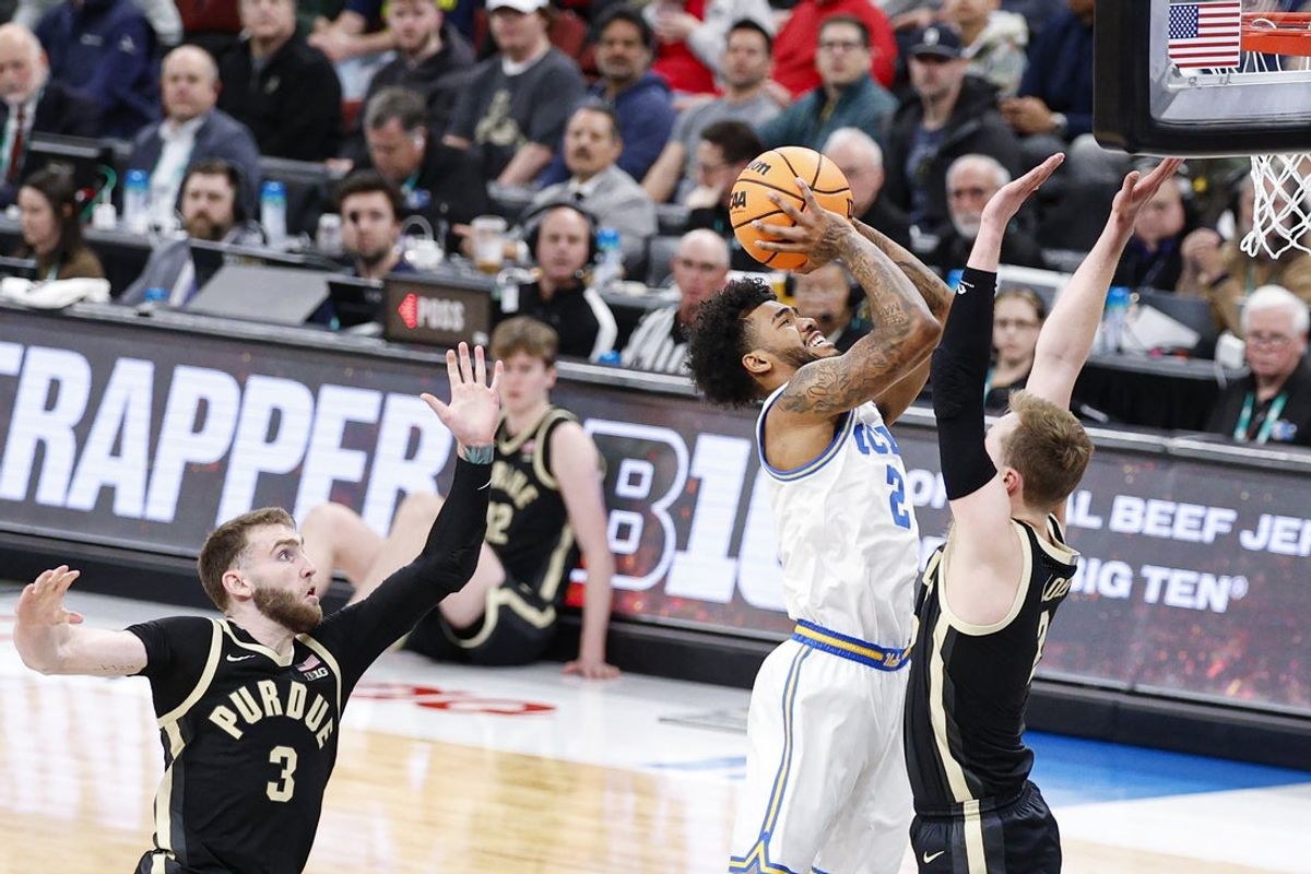 Mar 14, 2026; Chicago, IL, USA; UCLA Bruins guard Donovan Dent (2) goes to the basket against Purdue Boilermakers guard Fletcher Loyer (2) during the first half at United Center. Mandatory Credit: Kamil Krzaczynski-Imagn Images