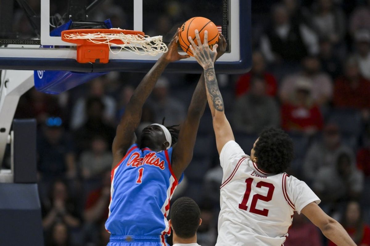 Mar 14, 2026; Nashville, TN, USA;  Arkansas Razorbacks forward Malique Ewin (12) blocks the shot of Mississippi Rebels forward Corey Chest (1) during the first half at Bridgestone Arena. Mandatory Credit: Steve Roberts-Imagn Images