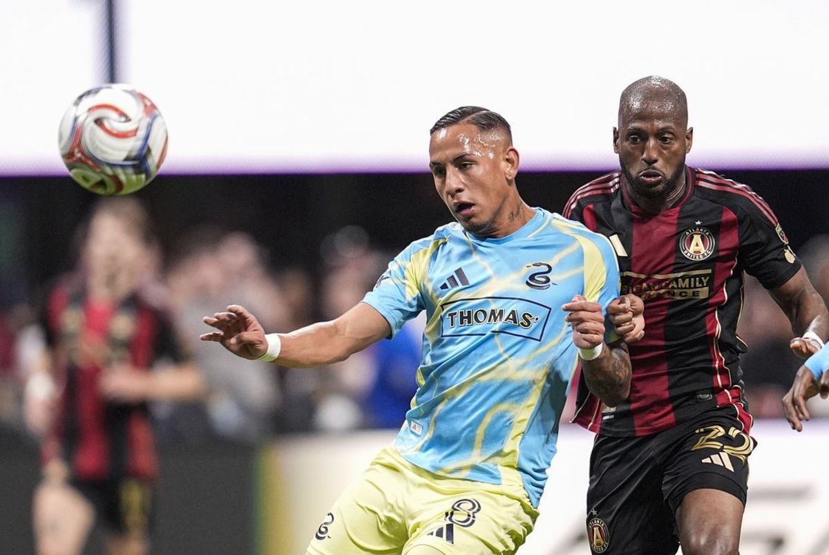 Mar 14, 2026; Atlanta, Georgia, USA; Philadelphia Union midfielder Jesus Bueno (8) and Atlanta United forward Fafà Picault (22) chase the ball during the second half at Mercedes-Benz Stadium. Mandatory Credit: Dale Zanine-Imagn Images