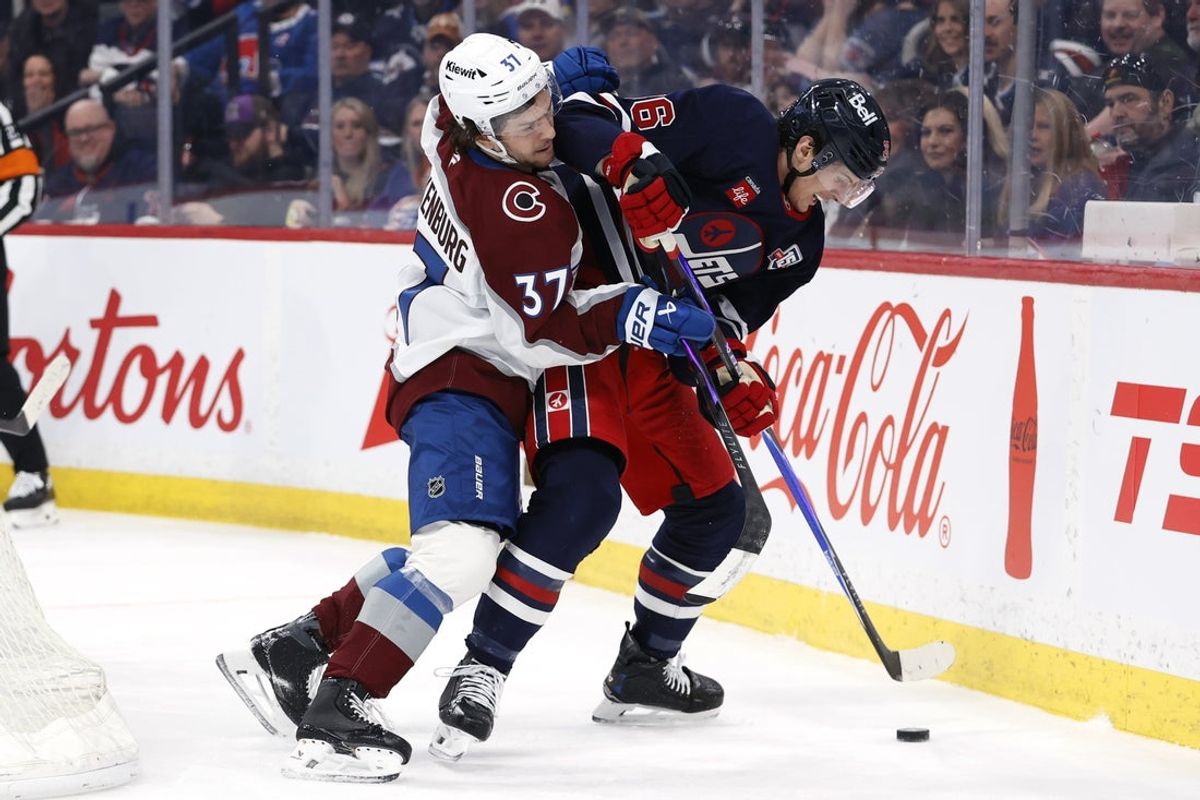 Mar 14, 2026; Winnipeg, Manitoba, CAN; Colorado Avalanche defenseman Nick Blankenburg (37) checks Winnipeg Jets center Morgan Barron (36) in the second period at Canada Life Centre. Mandatory Credit: James Carey Lauder-Imagn Images