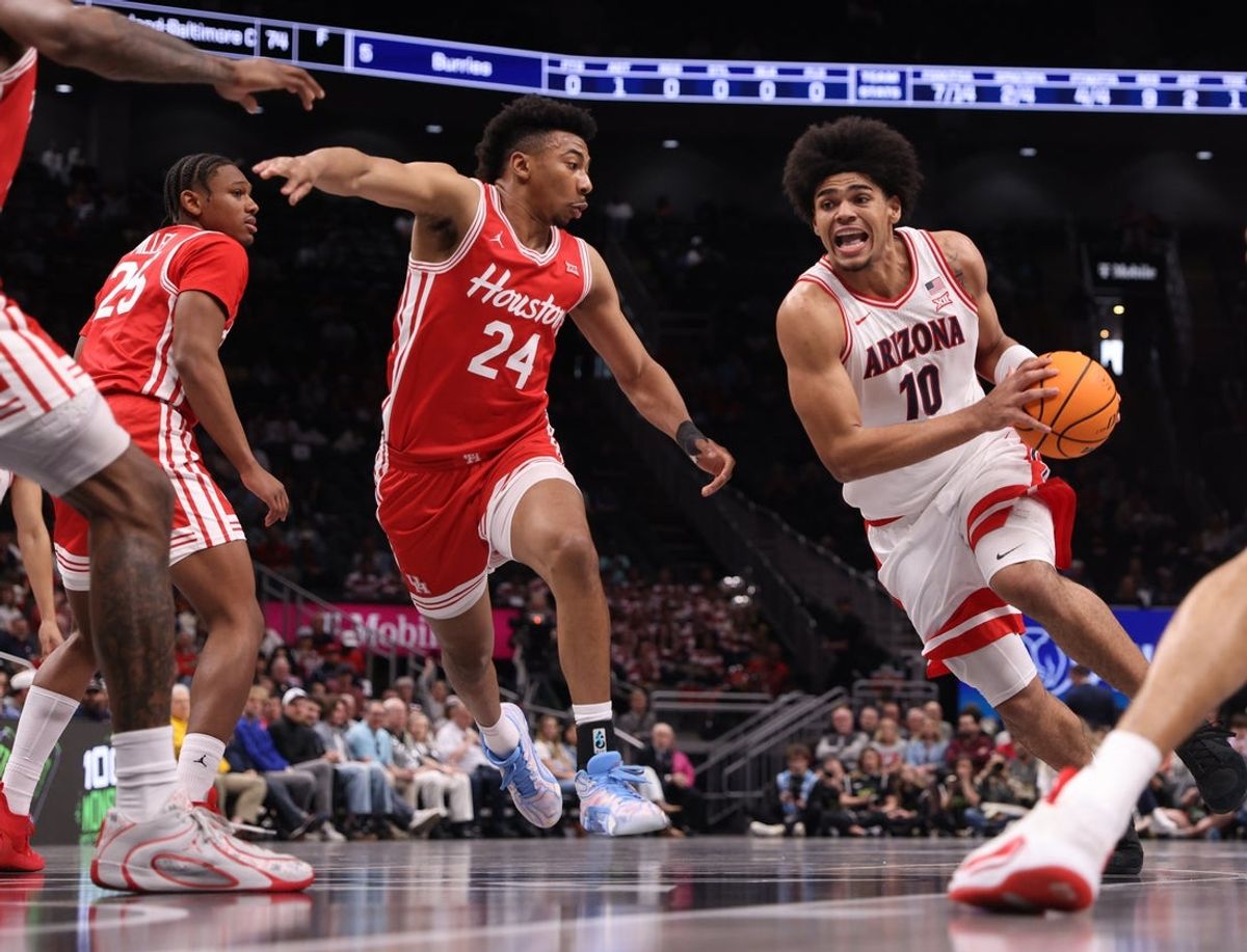 Mar 14, 2026; Kansas City, MO, USA; Arizona Wildcats forward Koa Peat (10) drives to the hoop past Houston Cougars forward Chase McCarty (24) during the first half during the men's Big 12 Conference Tournament Championship at T-Mobile Center. Mandatory Credit: William Purnell-Imagn Images