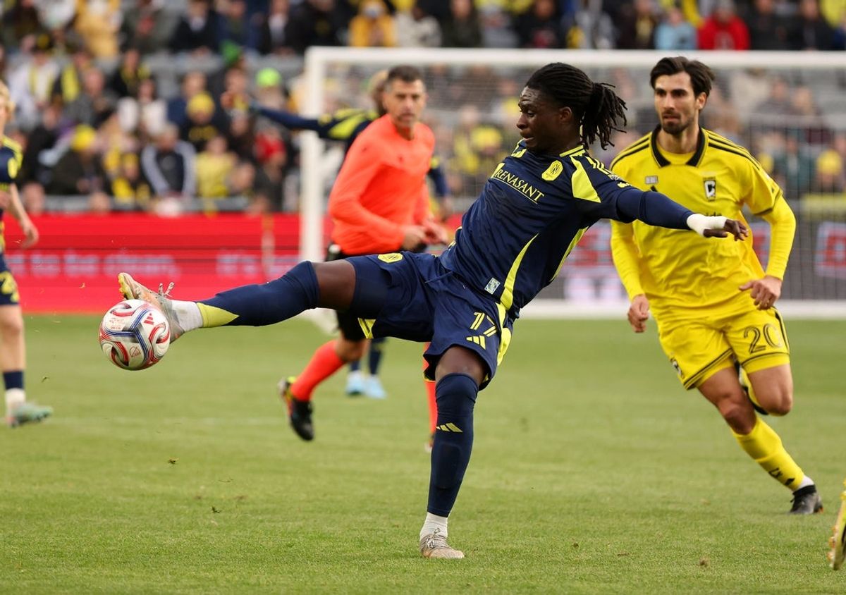 Mar 14, 2026; Columbus, Ohio, USA; Nashville SC forward Woobens Pacius (17) kicks the ball as Columbus Crew midfielder Malte Andre Gomes (20) defends during the first half at ScottsMiracle-Gro Field. Mandatory Credit: Joseph Maiorana-Imagn Images