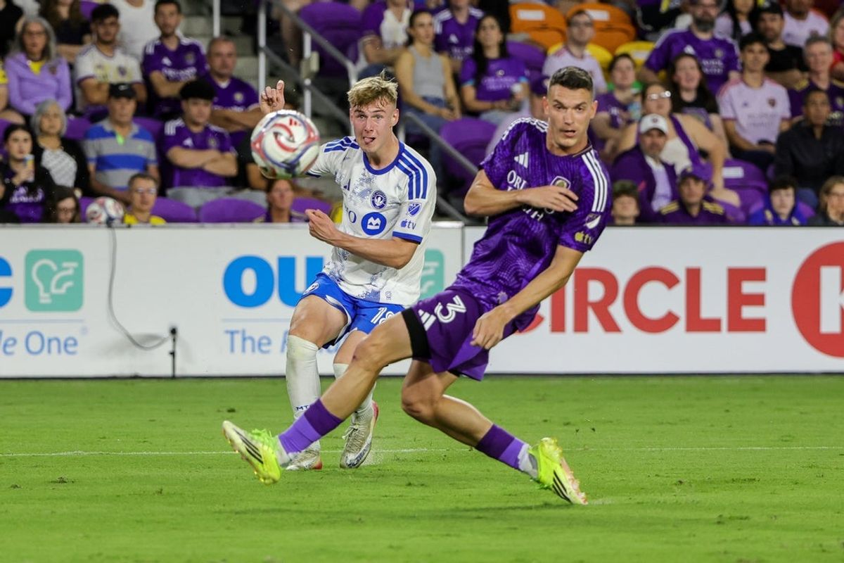 Mar 14, 2026; Orlando, Florida, USA; CF Montreal midfielder Hennadiy Synchuk (18) takes a shot on goal in front of Orlando City defender Adrian Marin (3) during the first half at Inter&Co Stadium. Mandatory Credit: Mike Watters-Imagn Images