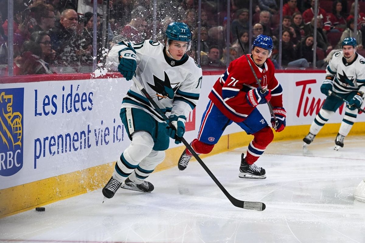Mar 14, 2026; Montreal, Quebec, CAN; San Jose Sharks center Macklin Celebrini (71) plays the puck against Montreal Canadiens center Jake Evans (71) during the second period at Bell Centre. Mandatory Credit: David Kirouac-Imagn Images
