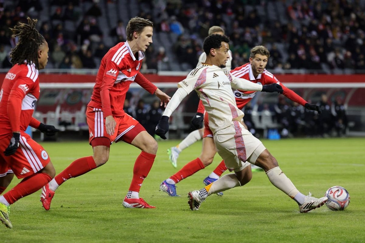 Mar 14, 2026; Chicago, Illinois, USA; D.C. United midfielder Brandon Servania (23) kicks the ball against Chicago Fire defender Jack Elliott (3) during the first half at Soldier Field. Mandatory Credit: Mike Dinovo-Imagn Images