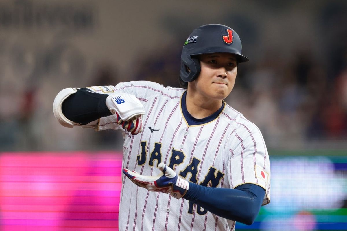 Mar 14, 2026; Miami, FL, United States; Japan designated hitter Shohei Ohtani (16) rounds the bases after hitting a home run against Venezuela in the first inning during a quarterfinal game of the 2026 World Baseball Classic at loanDepot Park. Mandatory Credit: Sam Navarro-Imagn Images