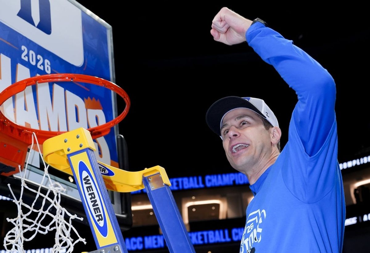 Mar 14, 2026; Charlotte, NC, USA; Duke Blue Devils head coach Jon Scheyer cuts down the net after defeating the Virginia Cavaliers in the men's ACC Conference Tournament Championship at Spectrum Center. Mandatory Credit: Jim Dedmon-Imagn Images
