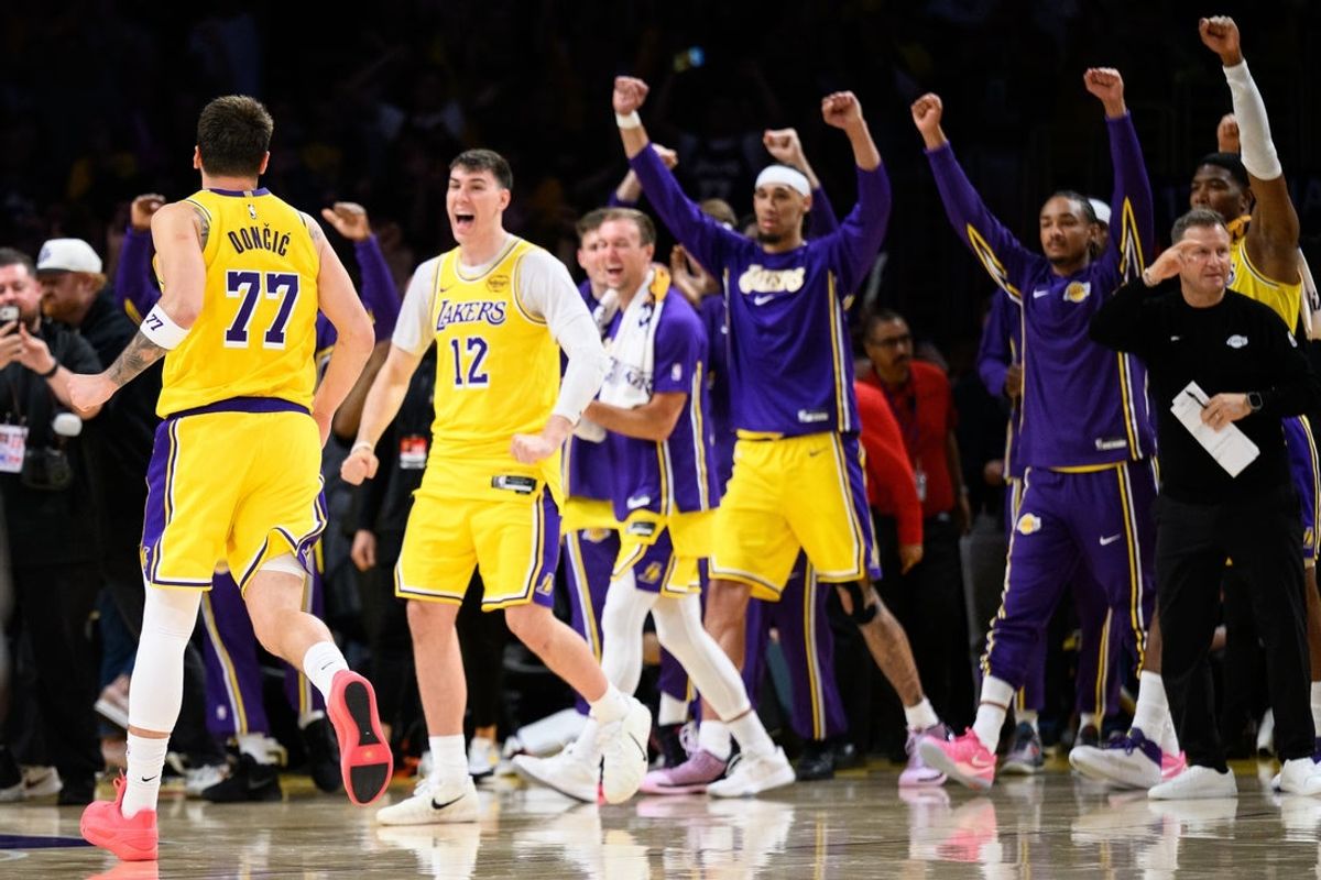 Mar 14, 2026; Los Angeles, California, USA; Los Angeles Lakers guard Luka Doncic (77) greets teammates after scoring a game winning shot during overtime against the Denver Nuggets at Crypto.com Arena. Mandatory Credit: William Liang-Imagn Images