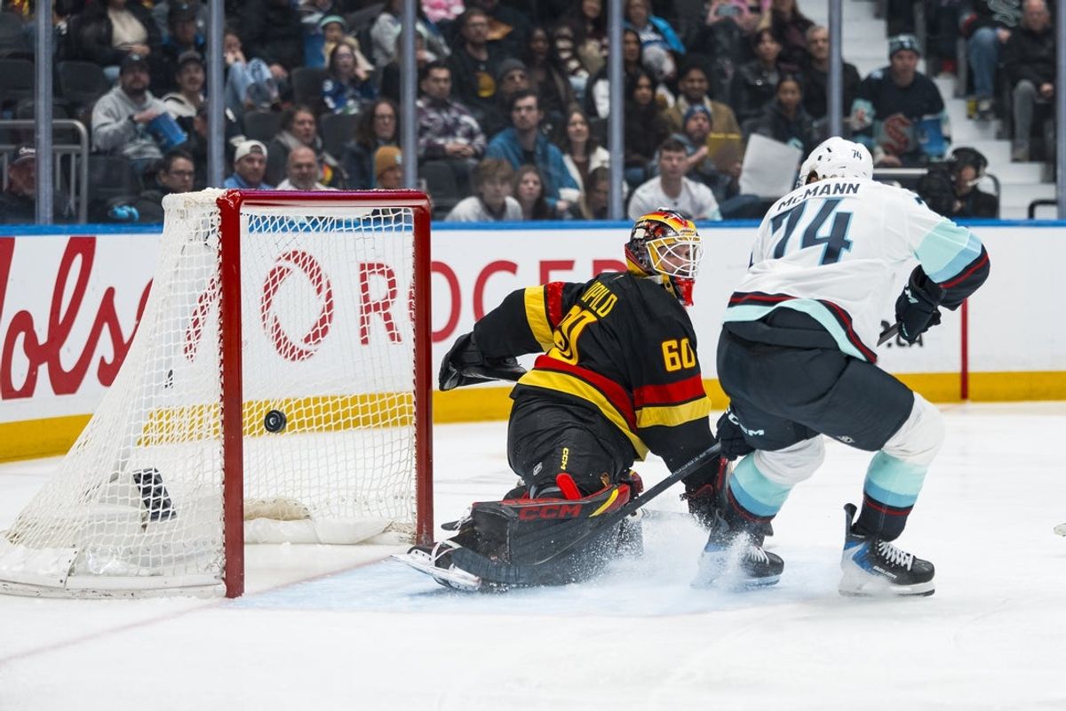 Mar 14, 2026; Vancouver, British Columbia, CAN; Seattle Kraken forward Bobby McMann (74) scores on Vancouver Canucks goalie Nikita Tolopilo (60) in the third period at Rogers Arena. Mandatory Credit: Bob Frid-Imagn Images