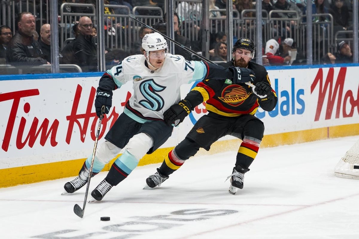 Mar 14, 2026; Vancouver, British Columbia, CAN; Seattle Kraken forward Bobby McMann (74) battles with Vancouver Canucks defenseman Filip Hronek (17) in the third period at Rogers Arena. Mandatory Credit: Bob Frid-Imagn Images