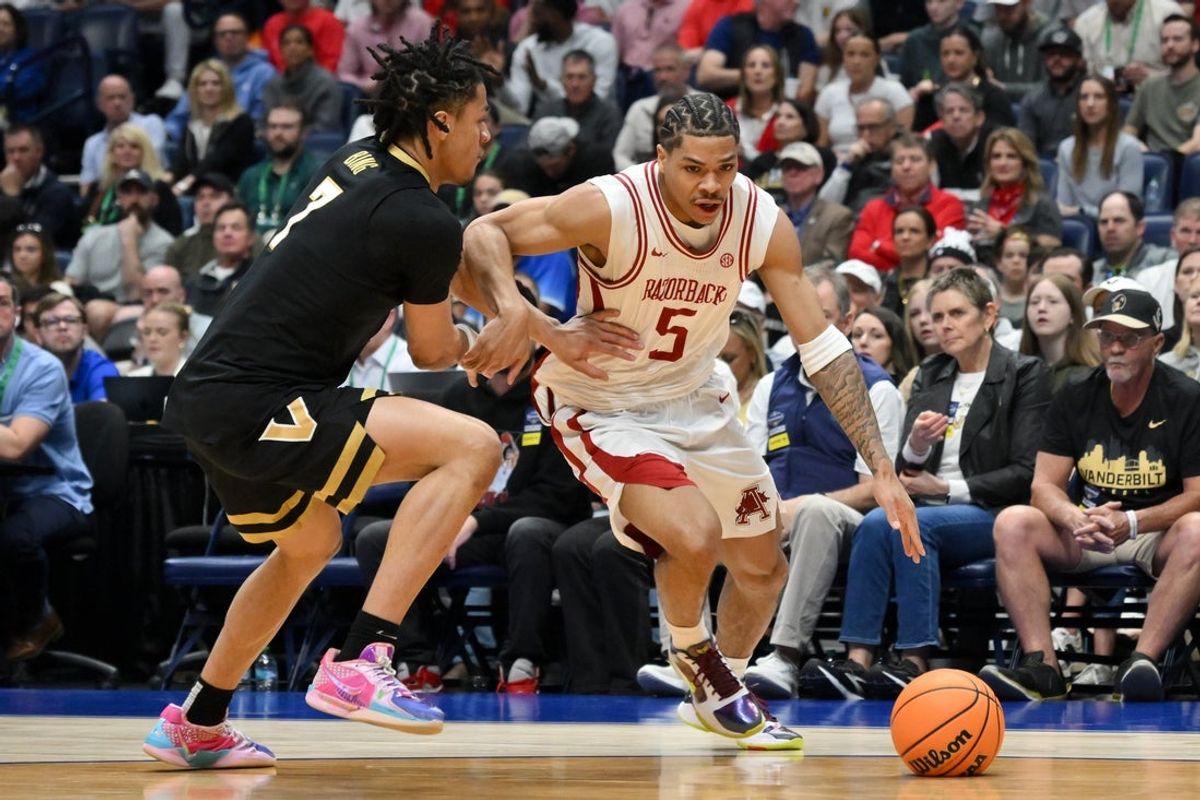 Mar 15, 2026; Nashville, TN, USA; Arkansas Razorbacks guard Darius Acuff Jr. (5) drives to the basket defended by Vanderbilt Commodores guard Chandler Bing (7) in the first half during the men's SEC Conference Tournament Championship at Bridgestone Arena. Mandatory Credit: Steve Roberts-Imagn Images