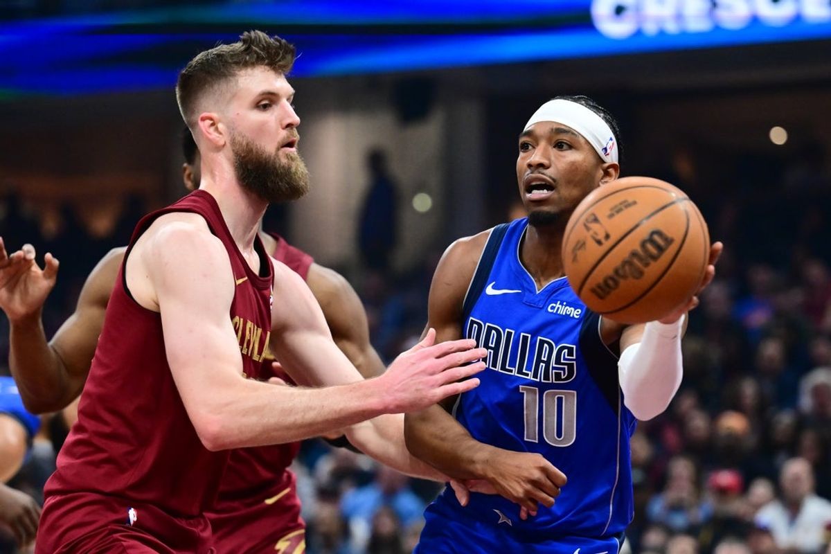 Mar 15, 2026; Cleveland, Ohio, USA; Dallas Mavericks guard Brandon Williams (10) looks to pass against  Cleveland Cavaliers forward Dean Wade (32) during the first half at Rocket Arena. Mandatory Credit: Ken Blaze-Imagn Images