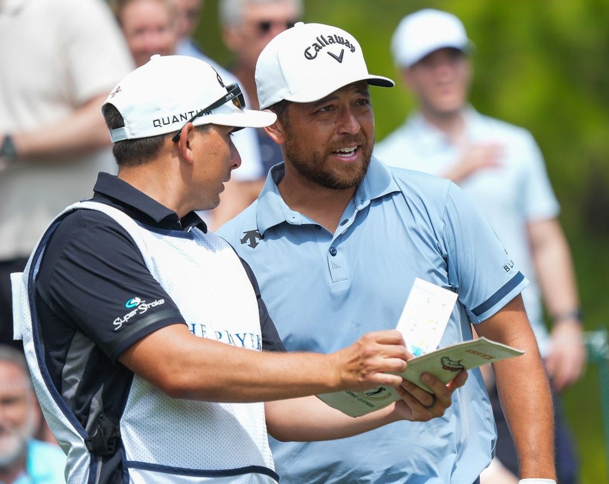 Xander Schauffele talks with his caddie Austin Kaiser before teeing off on the fourth hole during the final round ofThe Players Championship at The Players Stadium Course at TPC Sawgrass in Ponte Vedra Beach, Fla. Sunday March 15, 2026. [Doug Engle/Florida Times-Union]