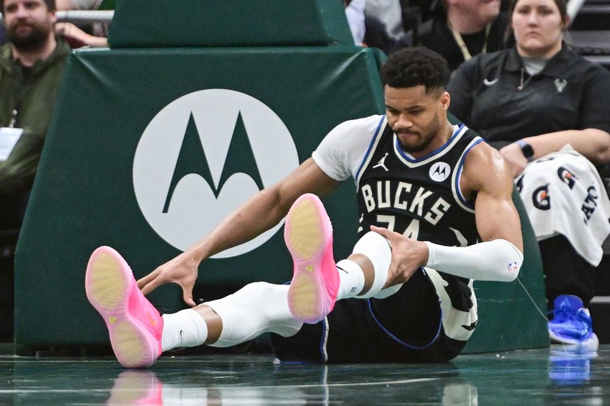 Mar 15, 2026; Milwaukee, Wisconsin, USA; Milwaukee Bucks forward Giannis Antetokounmpo (34) holds his knee after dunking a basket against the Indiana Pacers in the third quarter and had to leave the game at Fiserv Forum. Mandatory Credit: Benny Sieu-Imagn Images