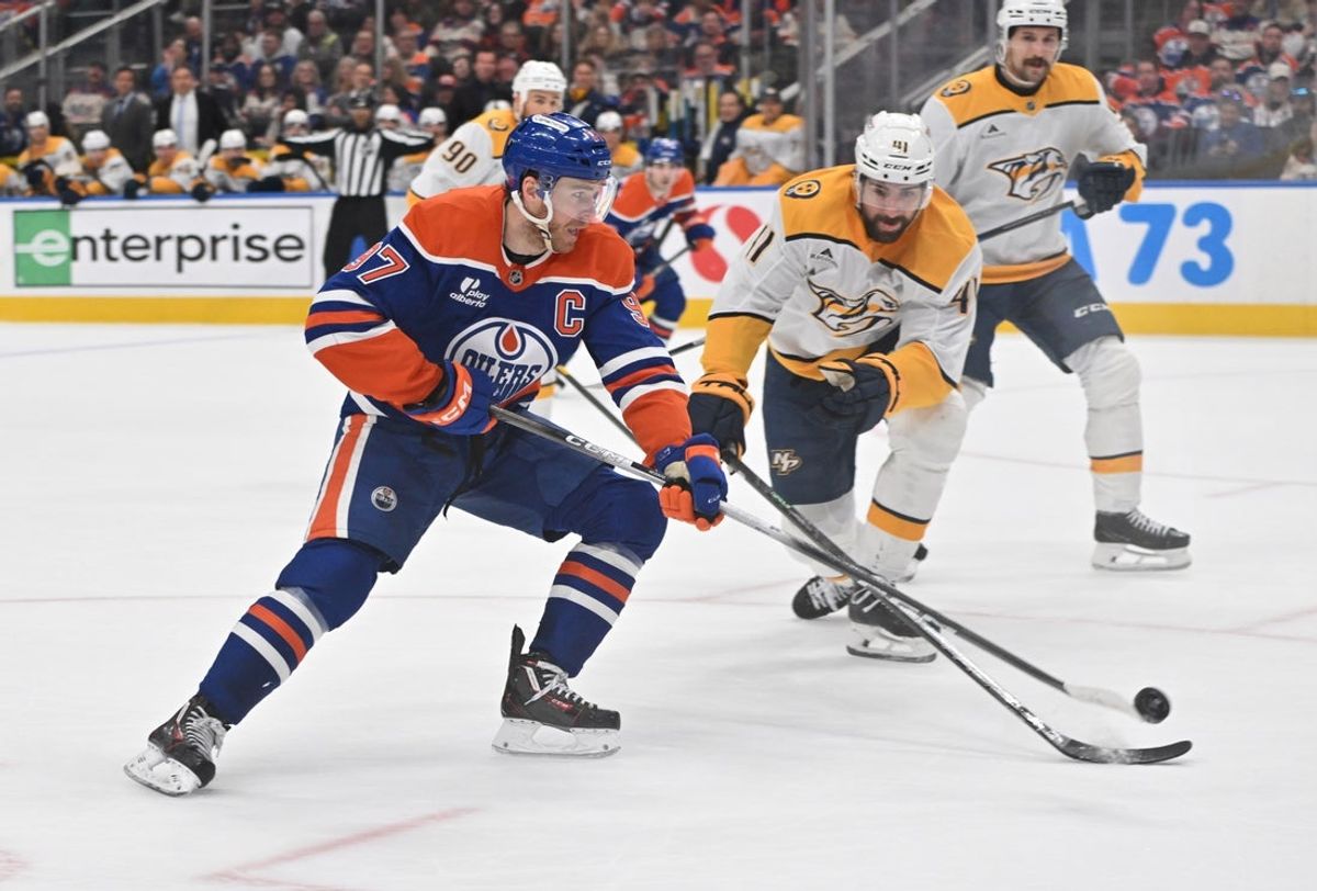 Mar 15, 2026; Edmonton, Alberta, CAN; Edmonton Oilers center Connor McDavid (97) and Nashville Predators defenseman Nicolas Hague (41) battle for the puck during the third period at Rogers Place. Mandatory Credit: Walter Tychnowicz-Imagn Images