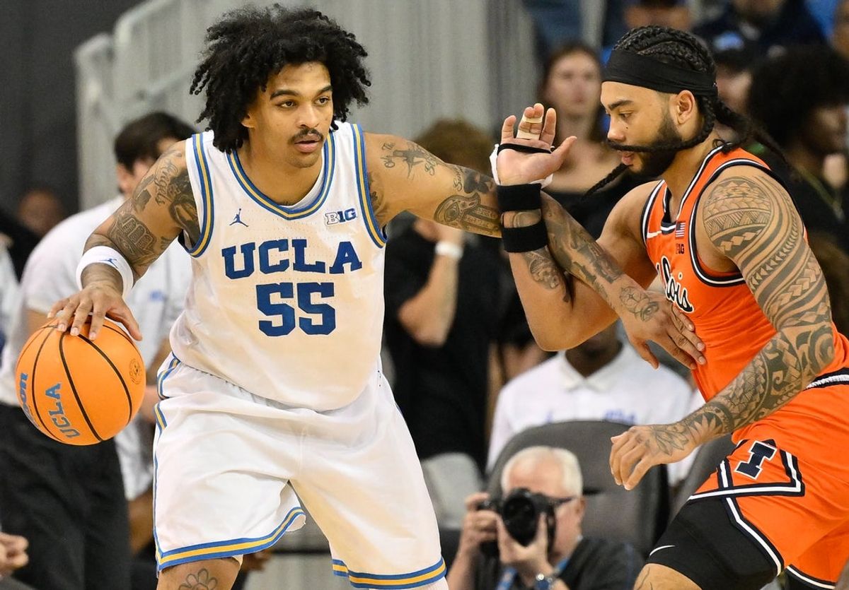 UCLA guard Skyy Clark (55) defended by Illinois guard Kylan Boswell (4) during the 2nd half at Pauley Pavilion presented by Wescom Financial. Mandatory Credit: Robert Hanashiro-Imagn Images
