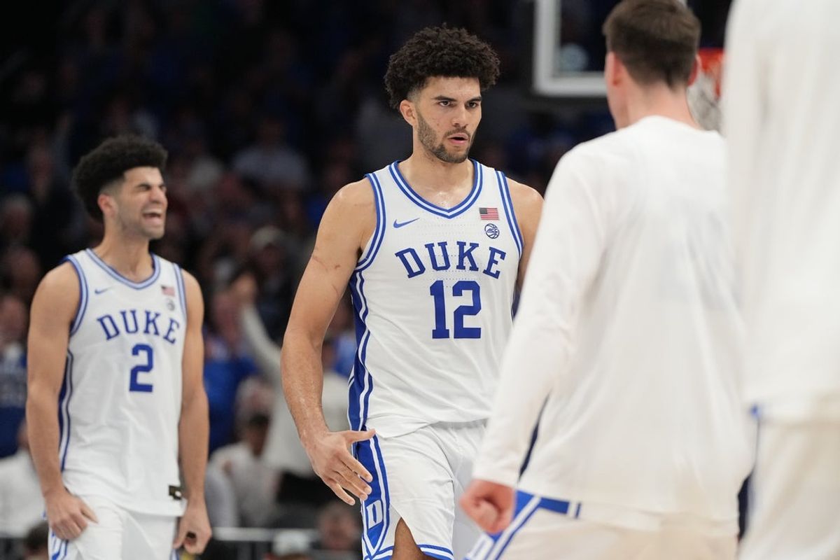 Mar 14, 2026; Charlotte, NC, USA; Duke Blue Devils forward Cameron Boozer (12) and guard Cayden Boozer (2) react in the second half during the men's ACC Conference Tournament Championship at Spectrum Center. Mandatory Credit: Bob Donnan-Imagn Images