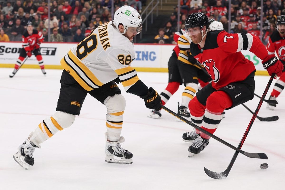 Mar 16, 2026; Newark, New Jersey, USA; Boston Bruins right wing David Pastrnak (88) and New Jersey Devils defenseman Dougie Hamilton (7) battle for the puck during the first period at Prudential Center. Mandatory Credit: Ed Mulholland-Imagn Images