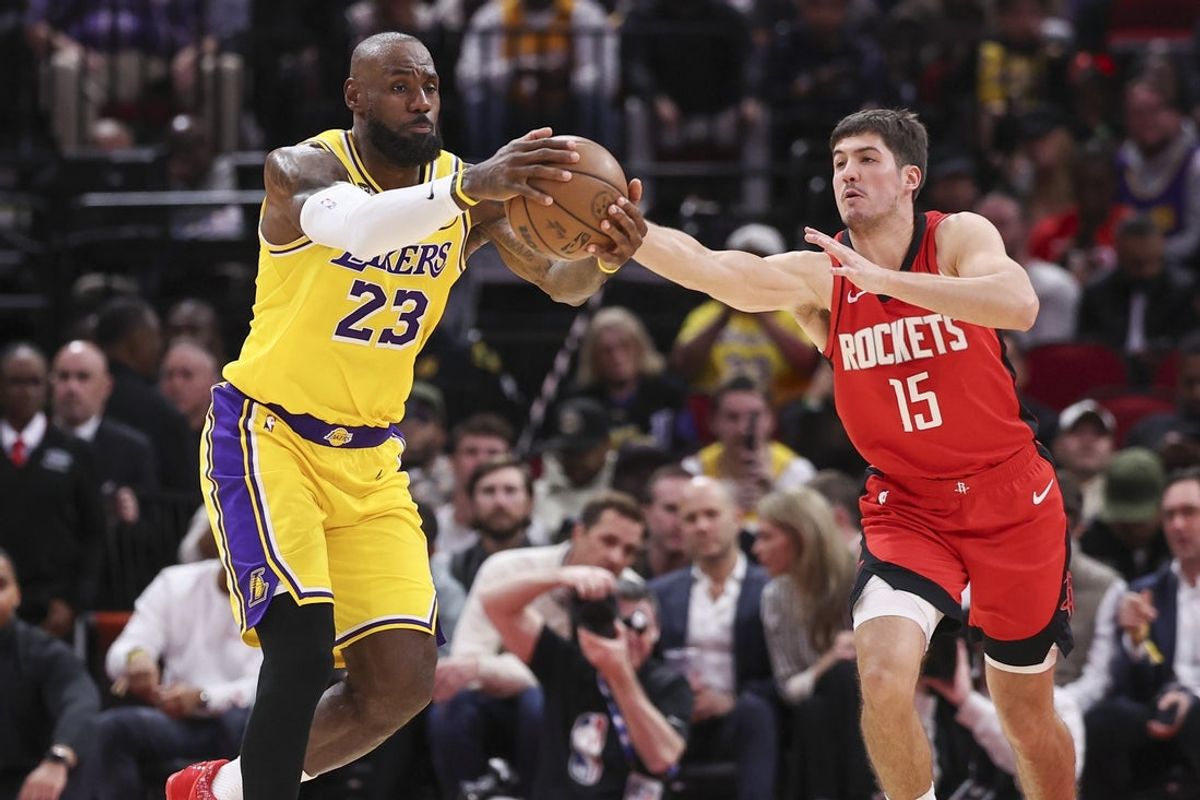 Mar 16, 2026; Houston, Texas, USA; Los Angeles Lakers forward LeBron James (23) and Houston Rockets guard Reed Sheppard (15) battle for the ball during the second quarter at Toyota Center. Mandatory Credit: Troy Taormina-Imagn Images