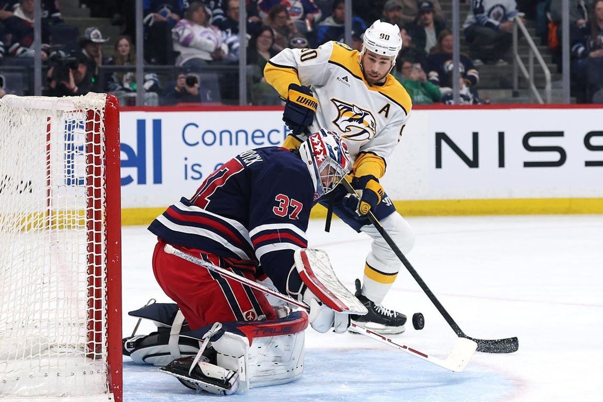 Mar 17, 2026; Winnipeg, Manitoba, CAN; Winnipeg Jets goaltender Connor Hellebuyck (37) stops a shot by Nashville Predators center Ryan O'Reilly (90) in the first period at Canada Life Centre. Mandatory Credit: James Carey Lauder-Imagn Images