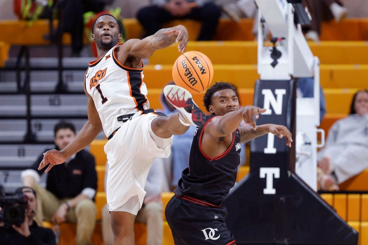 Oklahoma State Cowboys guard Kanye Clary (1) reaches for the ball beside Davidson Wildcats guard Josh Scovens (4) during a first-round basketball game in the National Invitational between the Oklahoma State Cowboys and the Davidson Wildcats at Gallagher-Iba Arena in Stillwater, Okla., Tuesday, March 17, 2026.