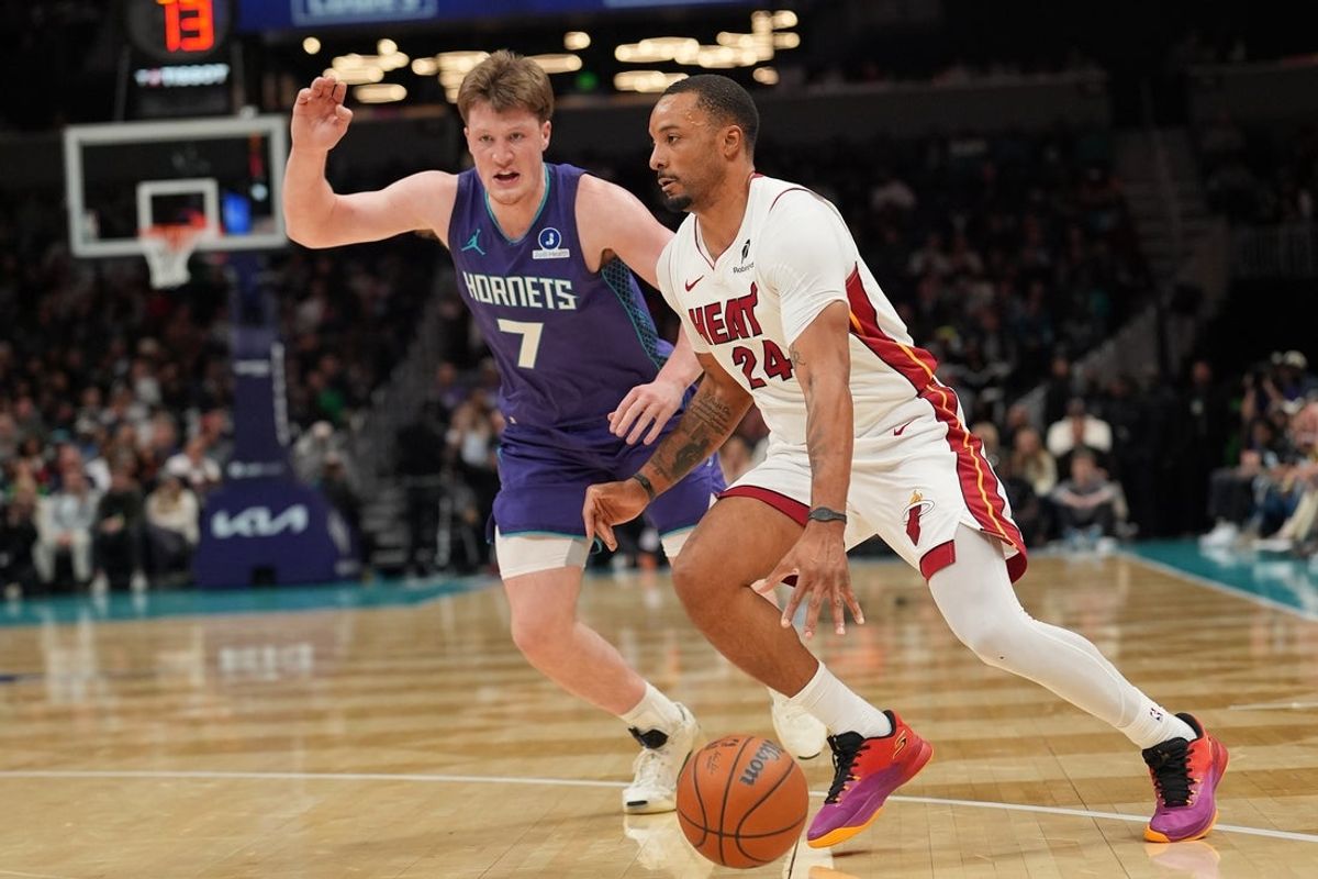 Mar 17, 2026; Charlotte, North Carolina, USA; Miami Heat guard Norman Powell (24) moves the ball against Charlotte Hornets guard Kon Knueppel (7) during the second half at Spectrum Center. Mandatory Credit: Jim Dedmon-Imagn Images