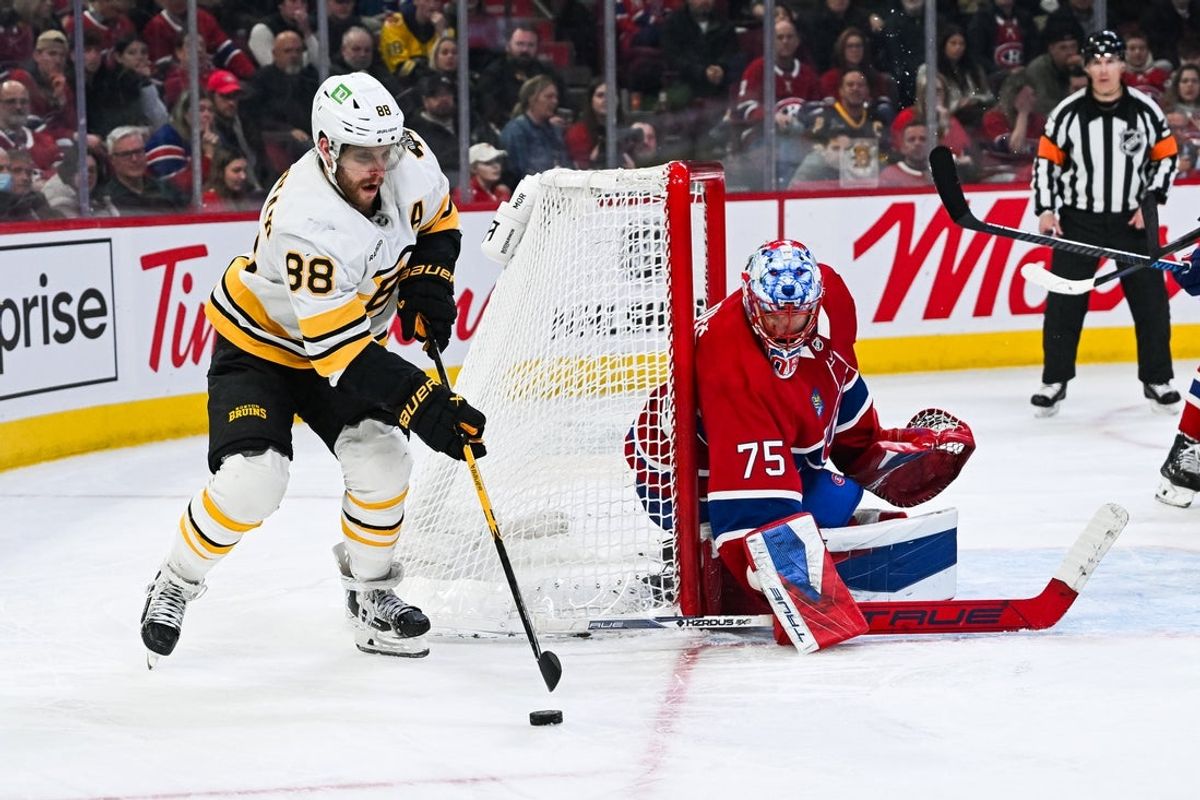 Mar 17, 2026; Montreal, Quebec, CAN; Boston Bruins right wing David Pastrnak (88) plays the puck against Montreal Canadiens goalie Jakub Dobes (75) during the third period at Bell Centre. Mandatory Credit: David Kirouac-Imagn Images