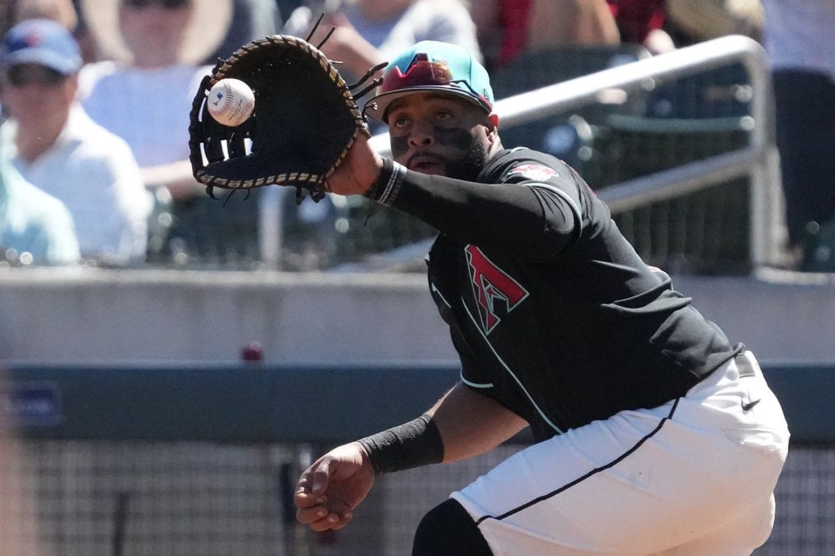 Mar 18, 2026; Salt River Pima-Maricopa, Arizona, USA; Arizona Diamondbacks first baseman Carlos Santana (41) makes the play against the Chicago Cubs in the first inning at Salt River Fields at Talking Stick. Mandatory Credit: Rick Scuteri-Imagn Images