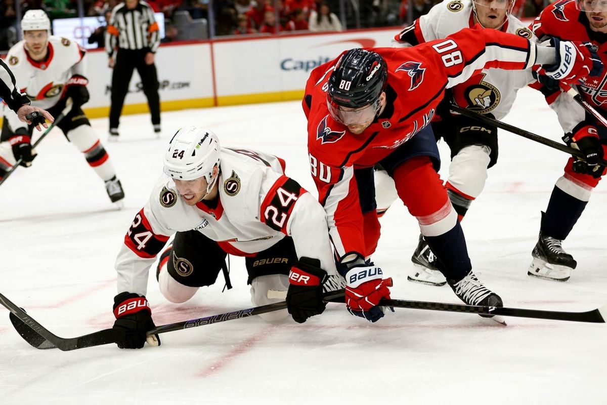 Mar 18, 2026; Washington, District of Columbia, USA; Ottawa Senators center Dylan Cozens (24) and Washington Capitals center Pierre-Luc Dubois (80) battle for possession during the first period at Capital One Arena. Mandatory Credit: Daniel Kucin Jr.-Imagn Images