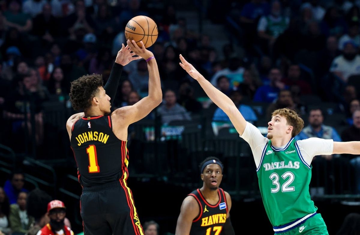 Mar 18, 2026; Dallas, Texas, USA; Atlanta Hawks forward Jalen Johnson (1) shoots over Dallas Mavericks forward Cooper Flagg (32) during the first quarter at American Airlines Center. Mandatory Credit: Kevin Jairaj-Imagn Images