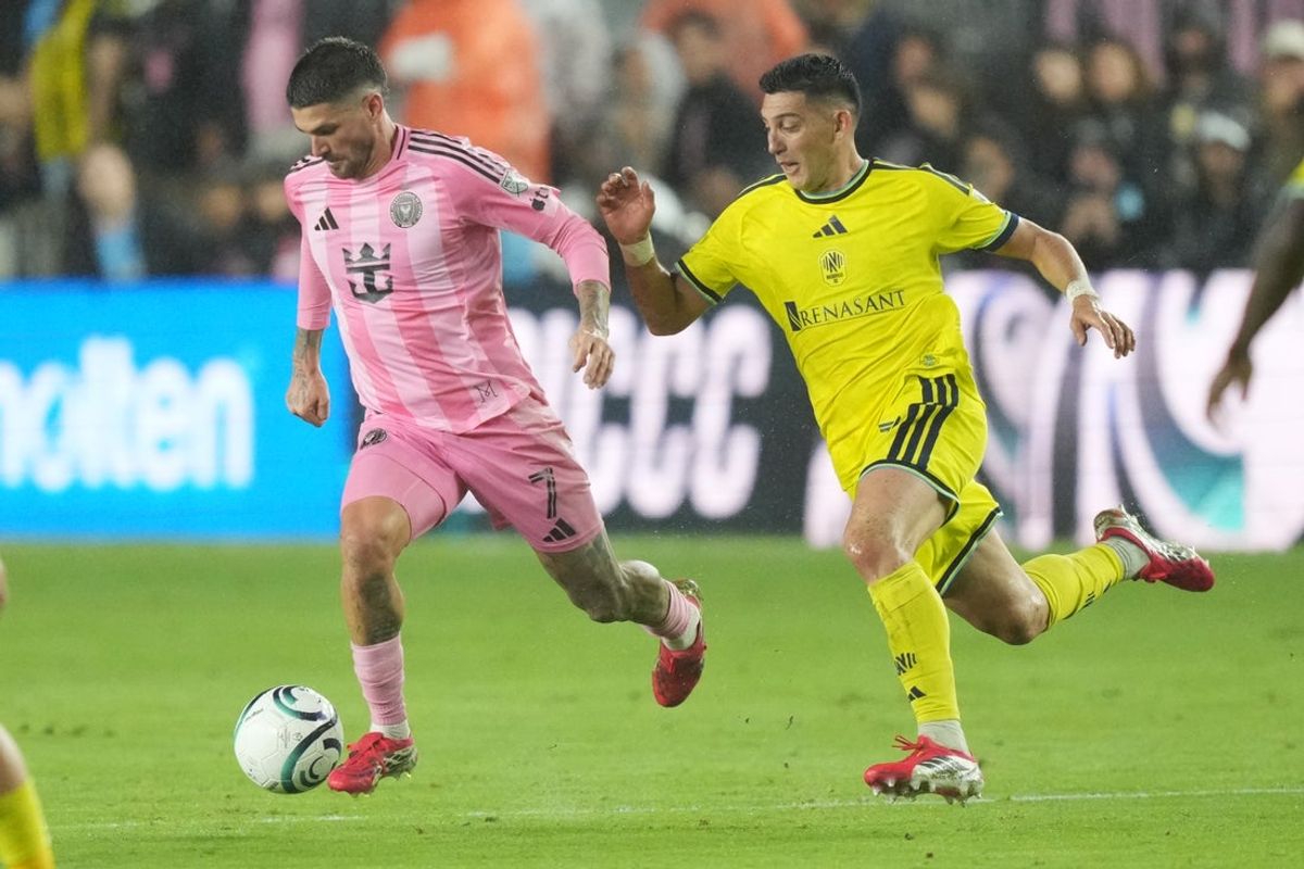 Mar 18, 2026; Fort Lauderdale, Florida, USA;  Inter Miami midfielder Rodrigo dePaul battles for possession against Nashville SC forward Cristian Espinoza (7) during the second half at Chase Stadium. Mandatory Credit: Jim Rassol-Imagn Images